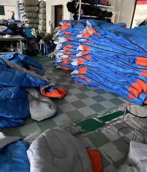 Stacks of blue and orange sleeping bags
