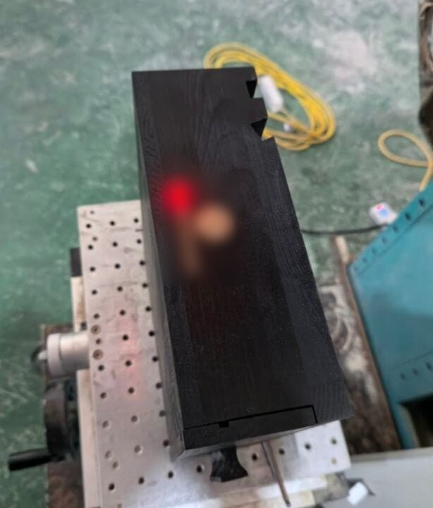 Dark wooden desk organiser under a laser engraver