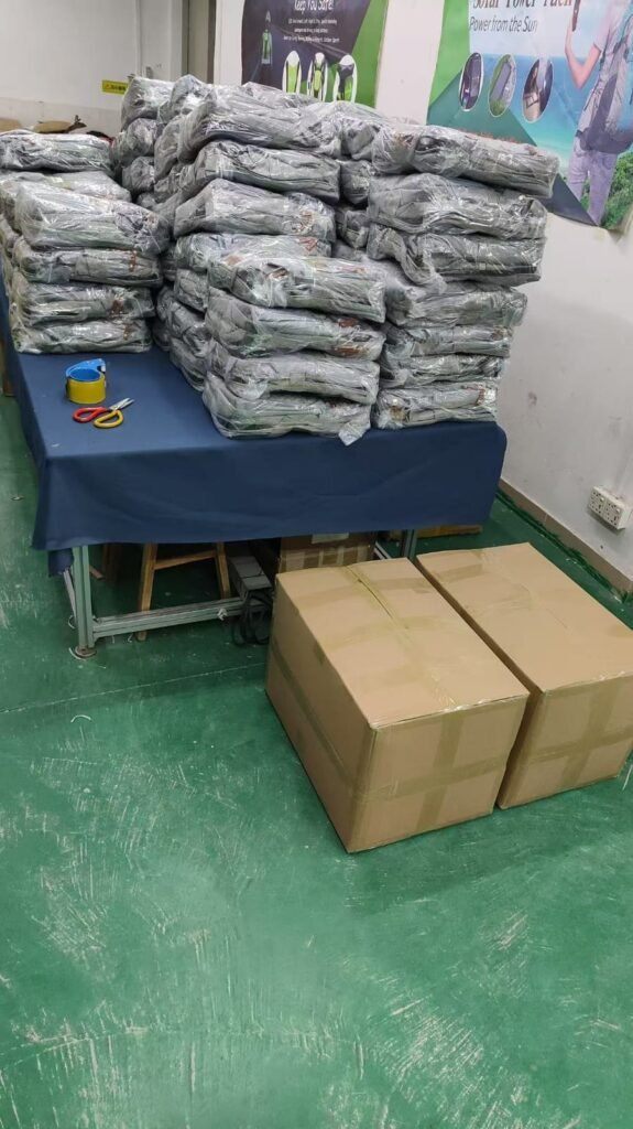 Packed units stacked on a table beside two cartons